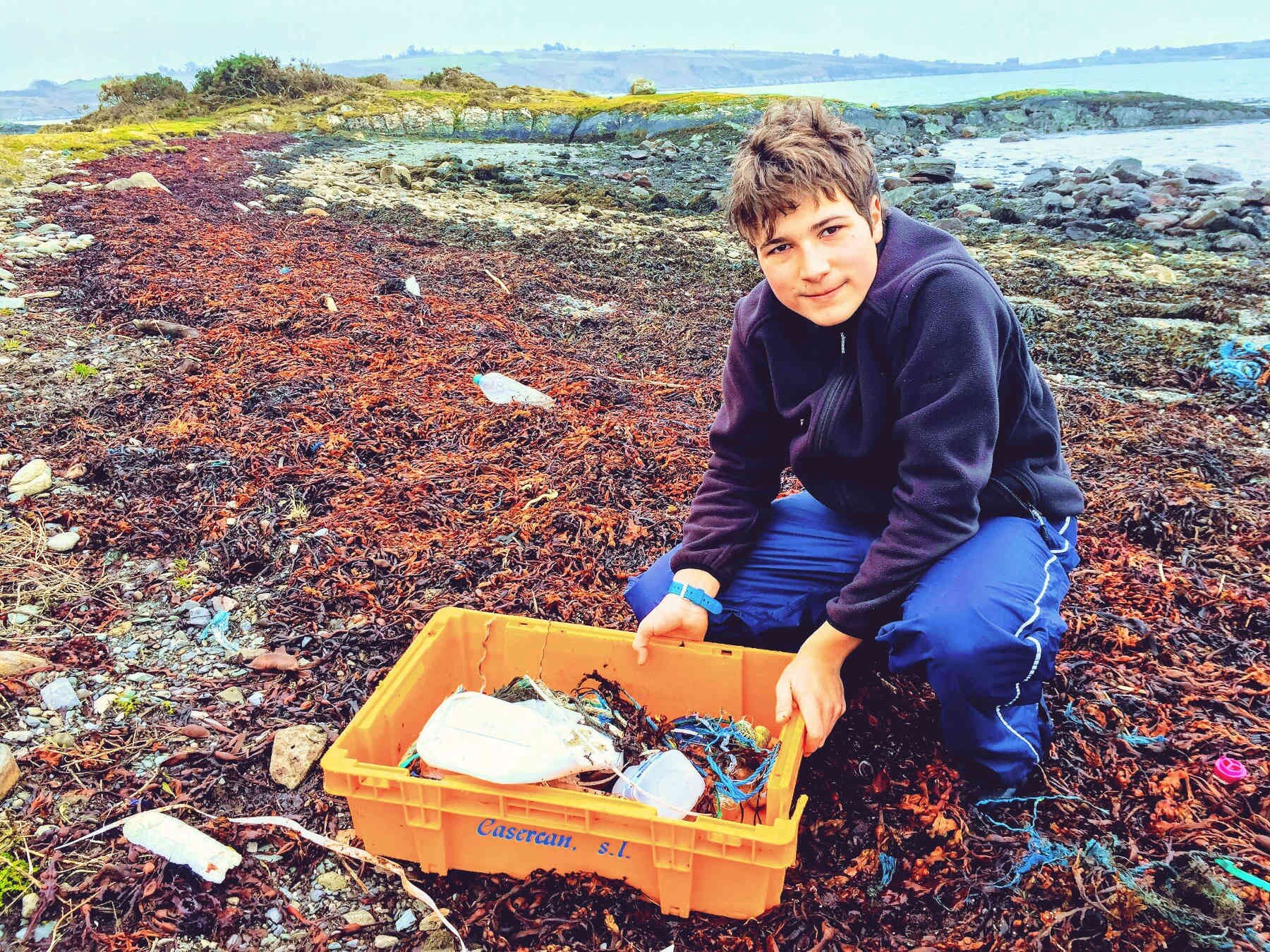 Fionn Ferreira collecting plastic waste